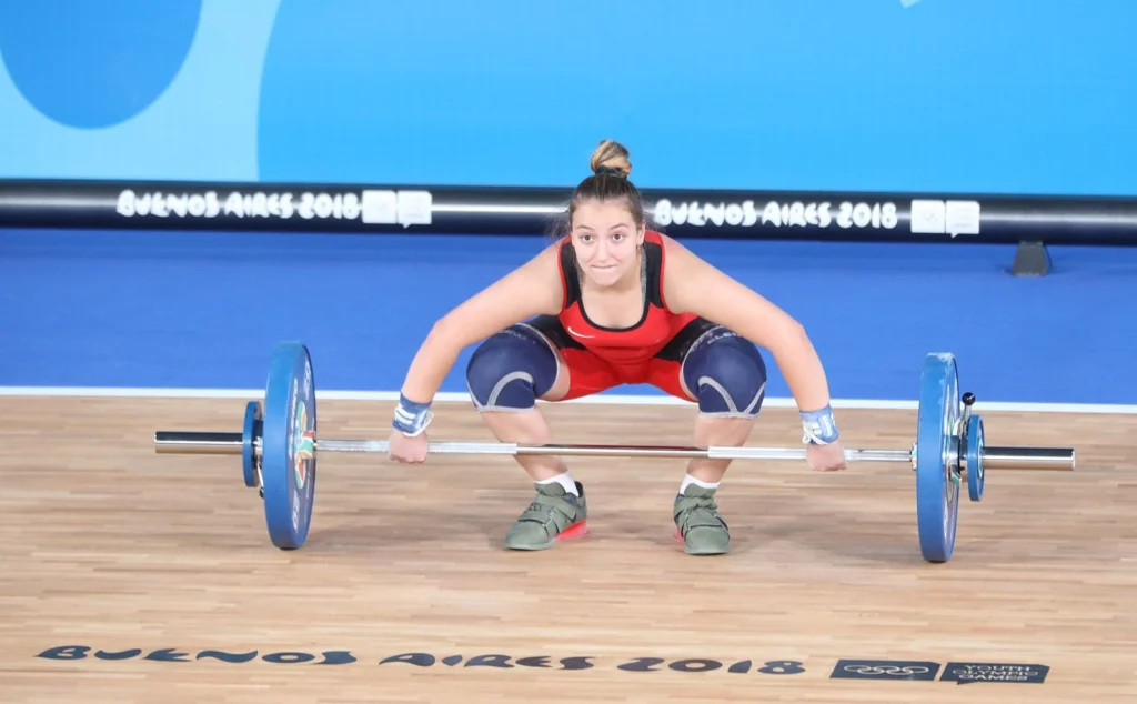 Female lifter setting her feet before a snatch